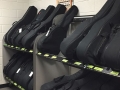 black guitar cases resting on a two-tiered shelf system