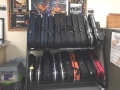 violin cases on shelves, next to a storage cabinet and under a bulletin board